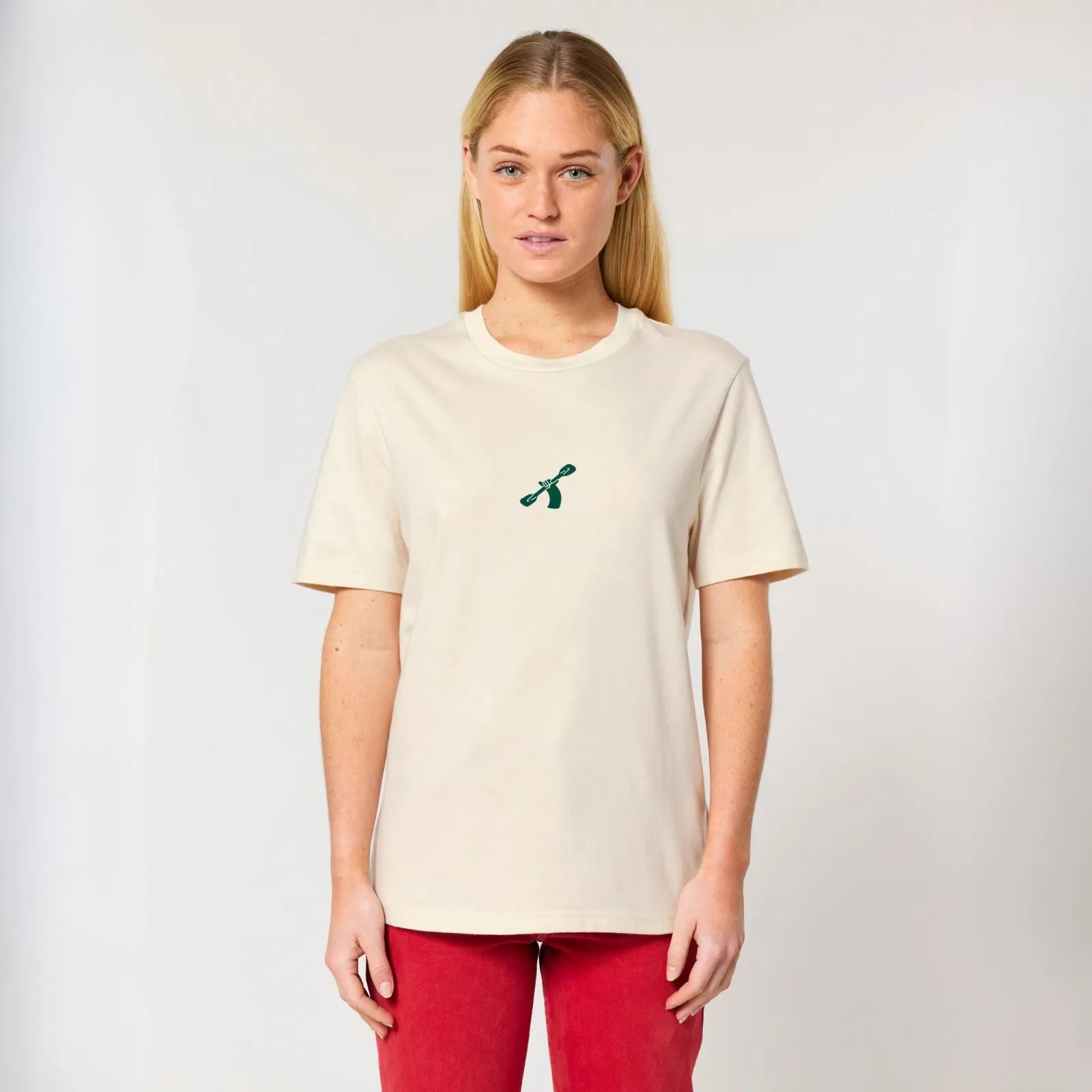 A woman wearing a City to Ocean T-shirt with &#39;City to Ocean&#39; logo design on the front. 100% Cotton in natural raw white, untreated sustainable fabric on plain background