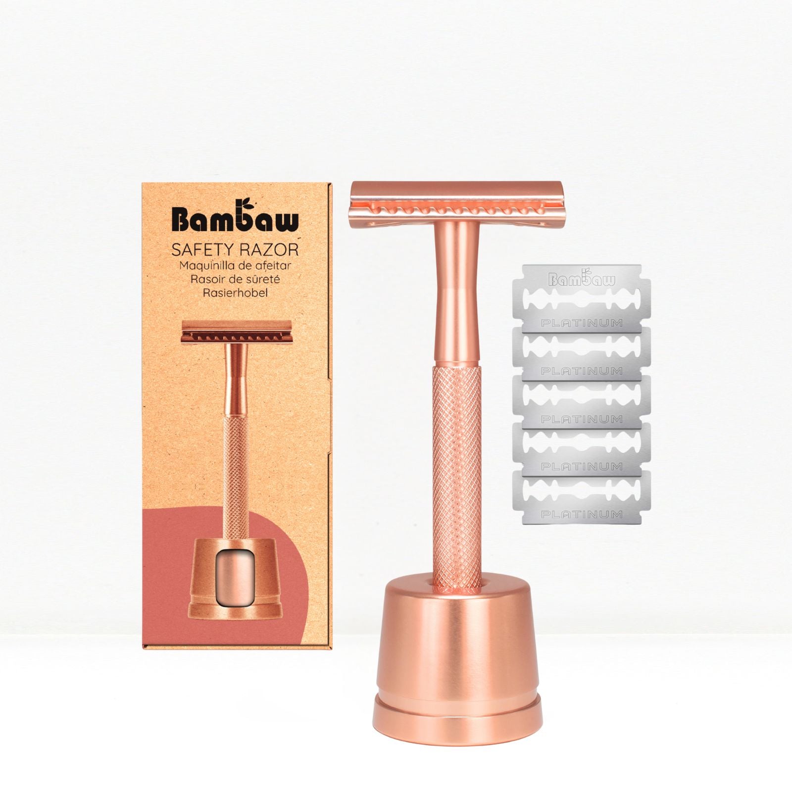 Bambaw Rose gold safety razor with stand and packaging and additional blades on a white background